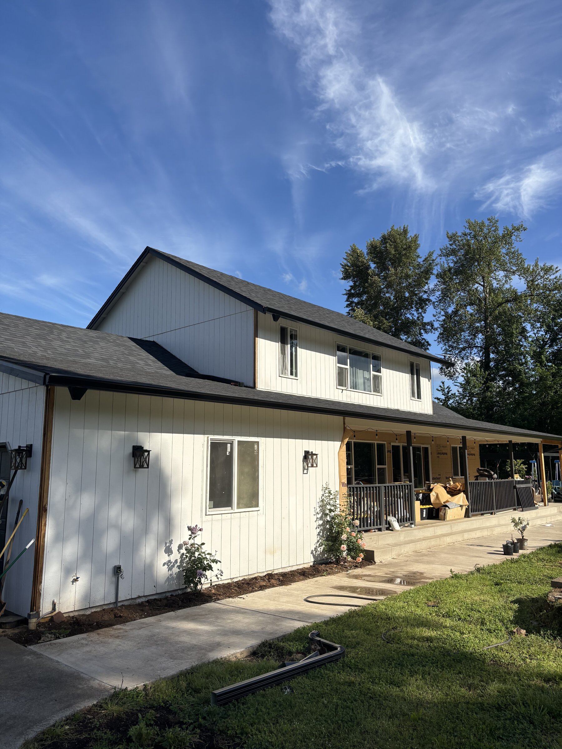 New siding and roof on two-story home with covered porch