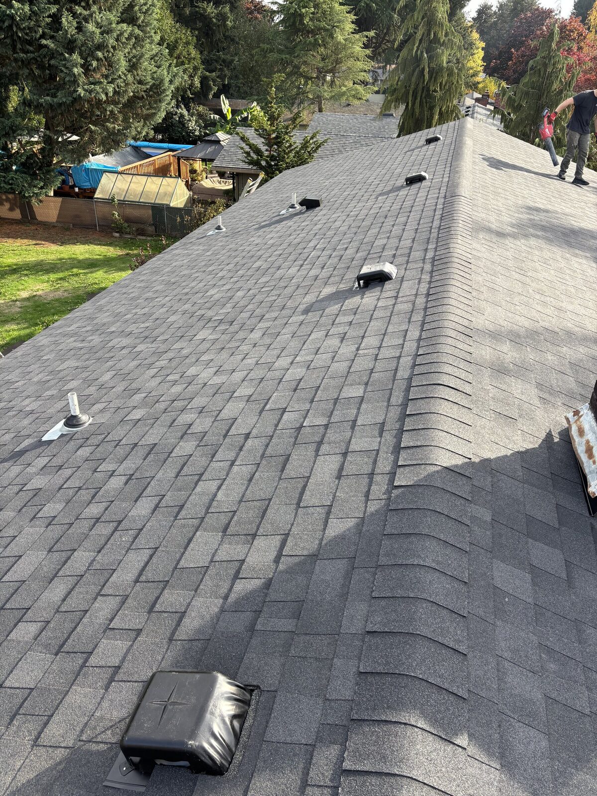 Roofer installing new architectural shingles